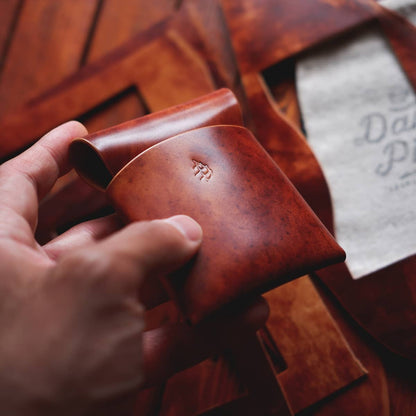 The Lodgepole Stitchless Wallet in Cognac Marbled Shell Cordovan leather held in hand