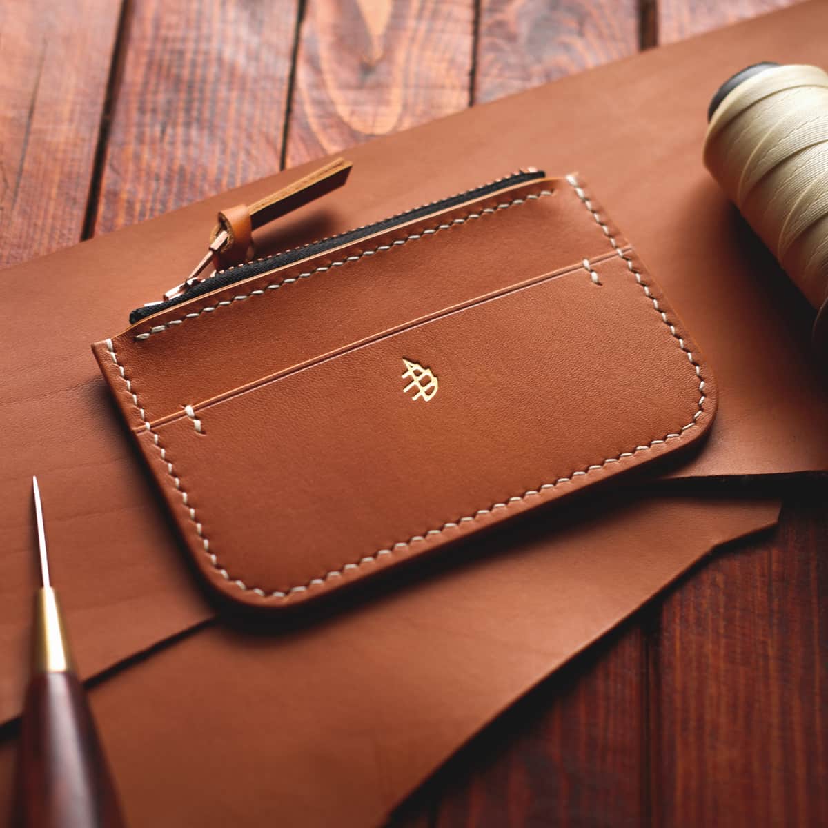 Tabletop view of The Coulter Zipper Wallet in premium light brown aniline veg tan leather