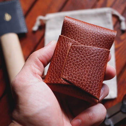 The Mini Lodgepole Stitchless Wallet in Brandy Dollaro leather held in hand - back side