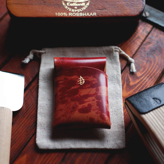Tabletop view of The Mini Lodgepole Stitchless Wallet in Red Rothko Shell Cordovan