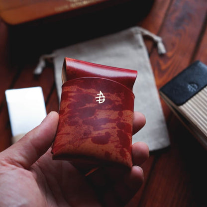 The Mini Lodgepole Stitchless Wallet in Red Rothko Shell Cordovan leather held in hand