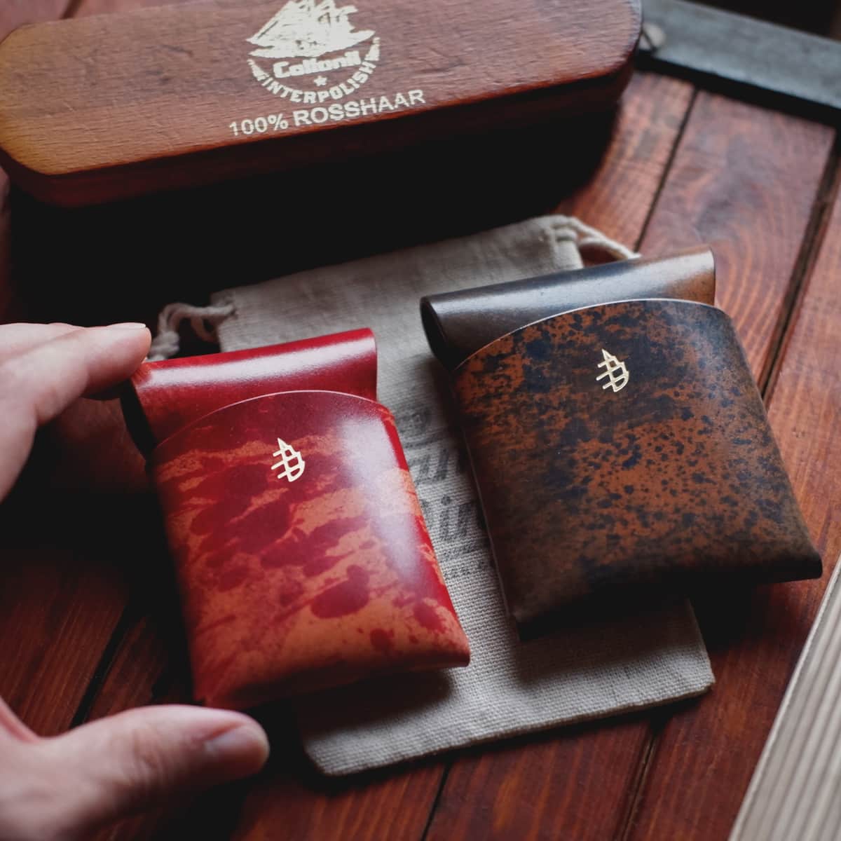 The Mini Lodgepole Stitchless Wallet in Red Rothko Shell Cordovan side by side with The Lodgepole Stitchless Wallet in Blue Rothko Shell Cordovan
