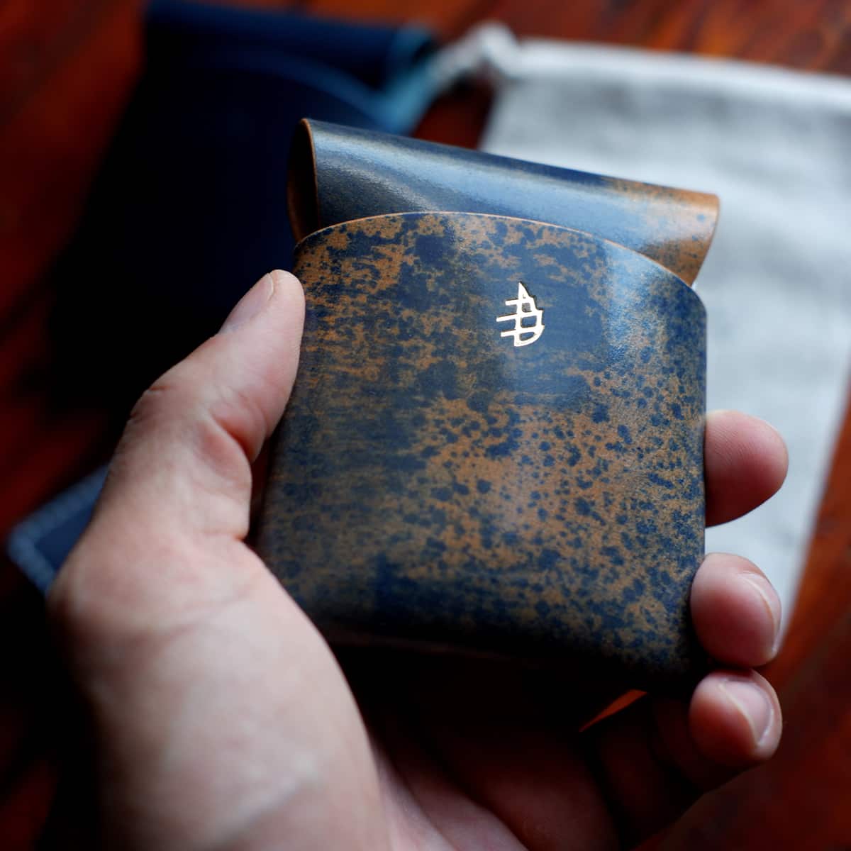 The Lodgepole Stitchless Wallet in Blue Rothko Shell Cordovan leather held in hand