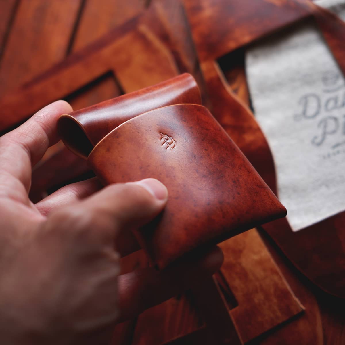 The Lodgepole Stitchless Wallet in Cognac Marbled Shell Cordovan leather held in hand