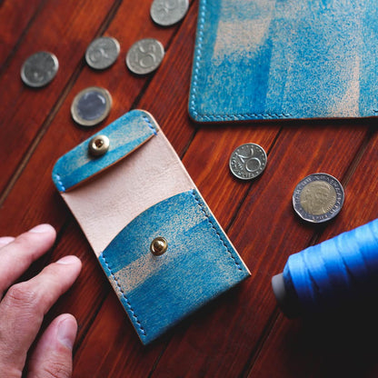 Tabletop view of The Mountain One Piece Coin Pouch in Sky Appaloosa full grain horse leather