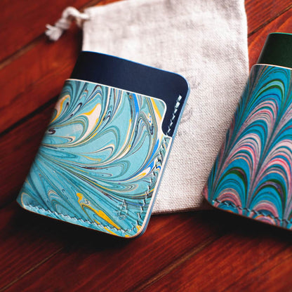 Tabletop view of The Vertical Card Holder in Blue Buttero and hand dyed marbled vegetable tanned leather