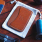 Tabletop view of The Arc Card Holder in Ruggine Koala and Cognac Tartufo full grain vegetable tanned leather