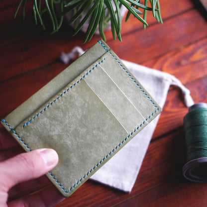 The Executive Card Wallet in Salvia Maya full grain vegetable tanned leather - front, held in hand