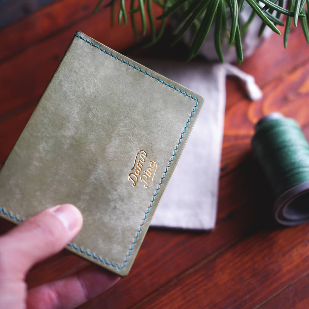The Executive Card Wallet in Salvia Maya full grain vegetable tanned leather - back, held in hand
