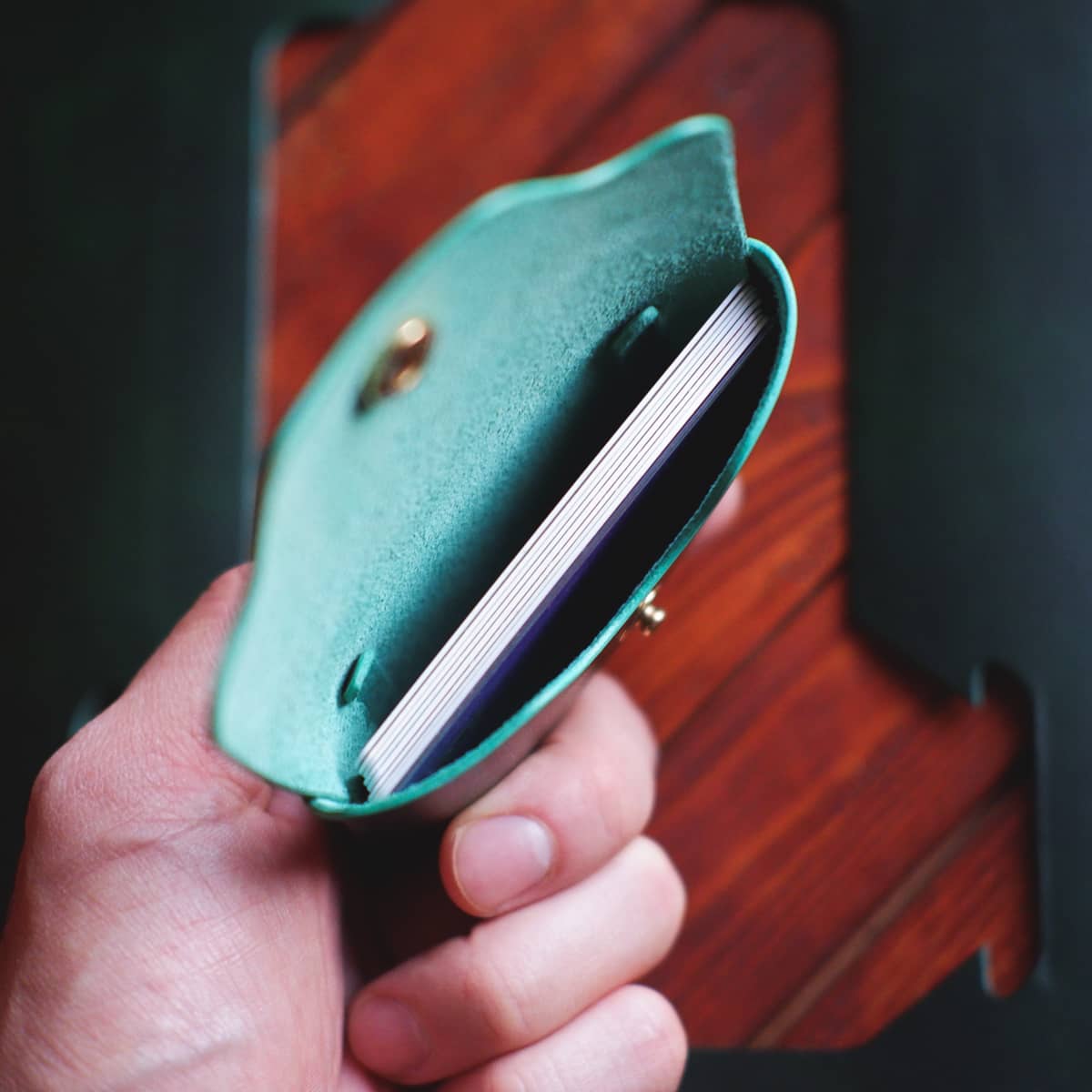 The Jack Stitchless Wallet in Verde Buttero Museum leather interior view with credit cards