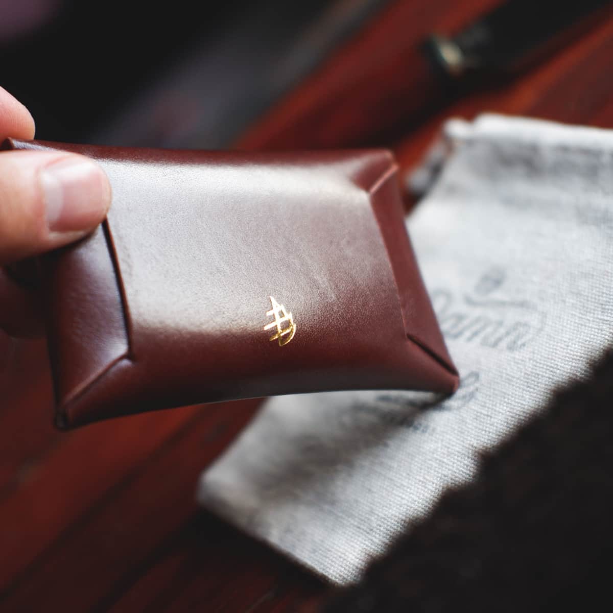 The Jack Stitchless Wallet in Firenze Lux leather held in hand - back side close up