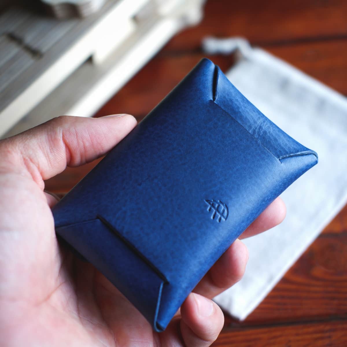 Back side of The Jack Stitchless Wallet in Cobalt Blue Vachetta held in hand