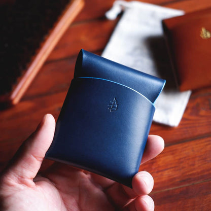 The Lodgepole Stitchless Wallet in Blue Buttero leather held in hand