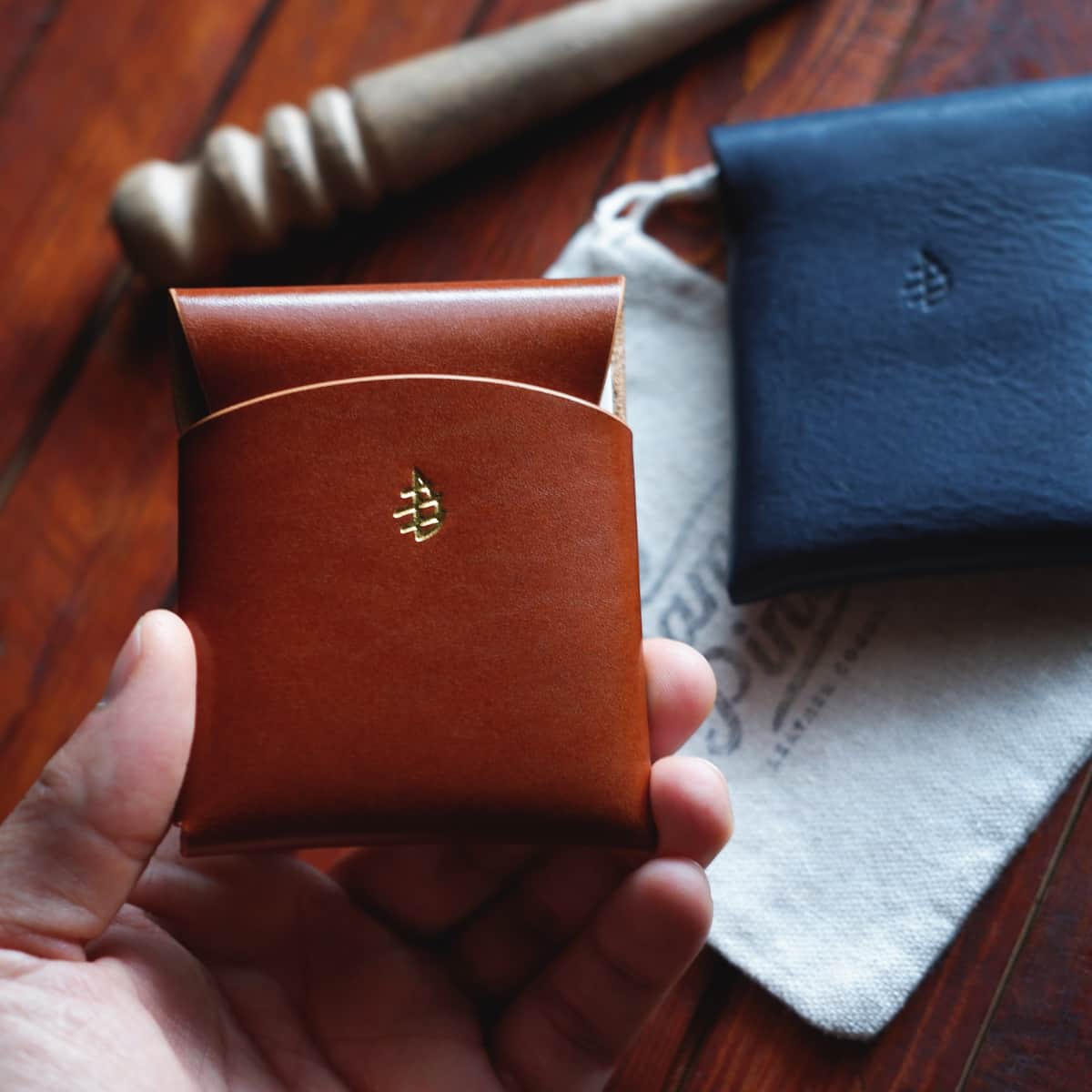 The Lodgepole Stitchless Wallet in Firenze Lux leather held in hand
