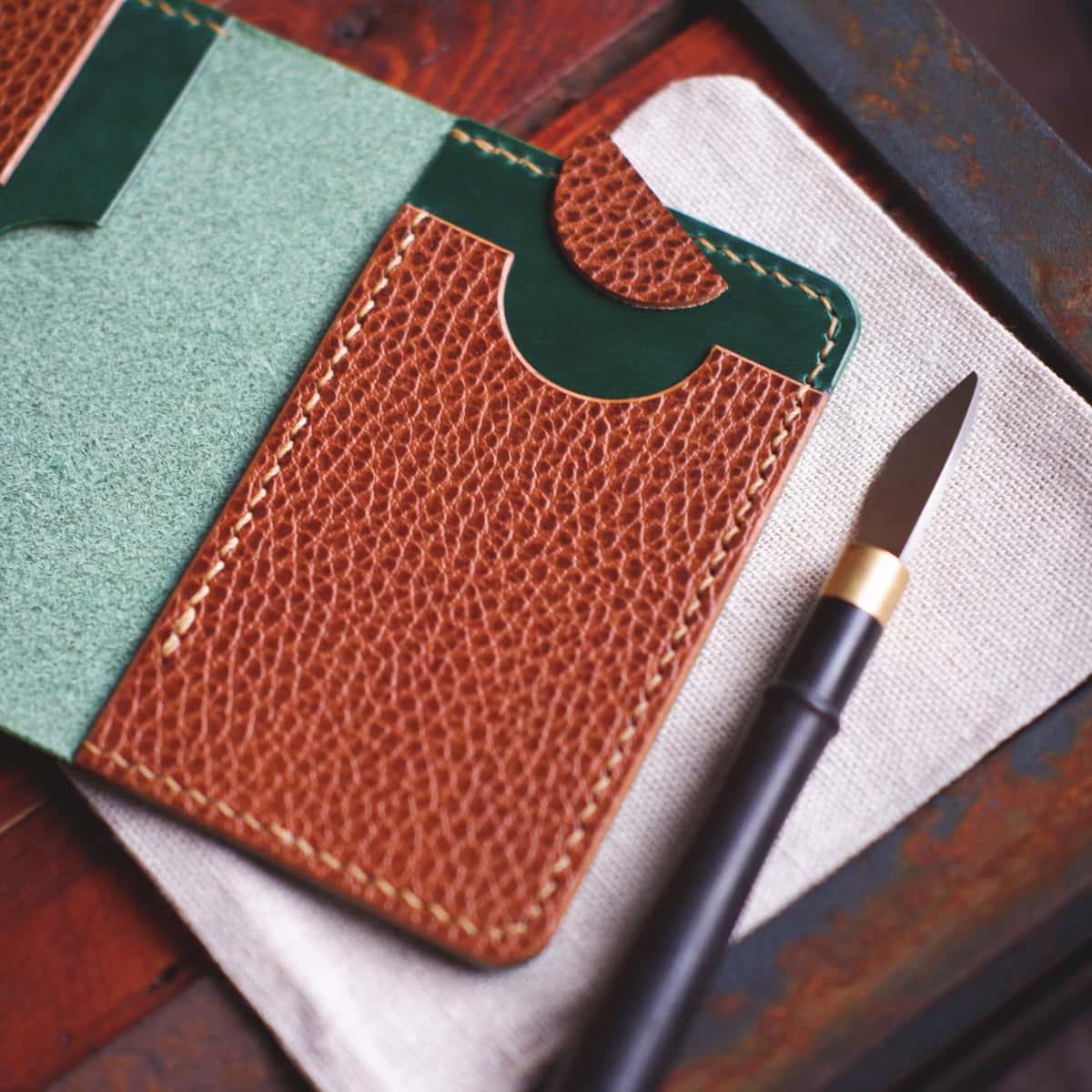 Interior view of the The Monterey 4-Slot Bifold wallet in Dollaro and Emerald Green Gaucho Oil leather