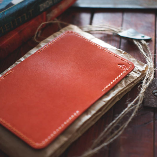 Tabletop view of The Monterey Slim Bifold in orange Gaucho Oil leather