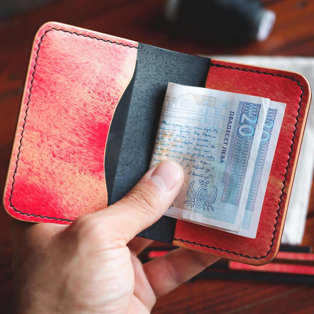 Closeup of The Monterey 3-Slot Bifold wallet with banknotes inside