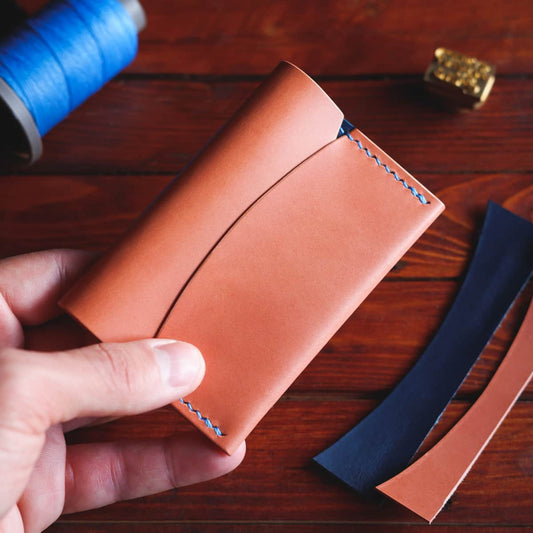 The Mountain Card Wallet in Buttero leather - front, closed, held in hand