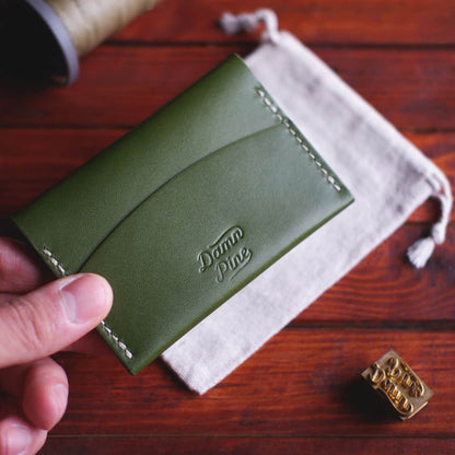 The Mountain Card Wallet held in hand - back side with quick access pocket