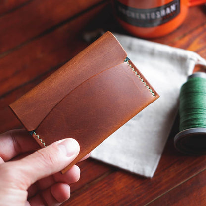 The Mountain Card Wallet - front, closed, held in hand