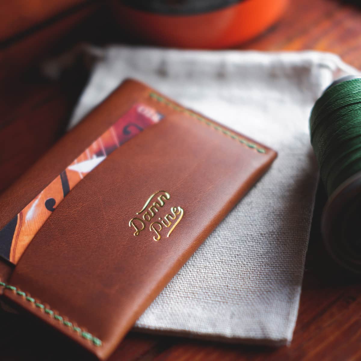 Closeup of The Mountain Card Wallet with Damn Pine Leather Goods logo