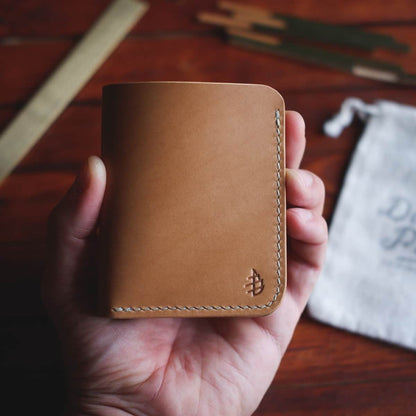The Mountain Open Top Bifold wallet in Buttero full grain vegetable tanned leather held in hand