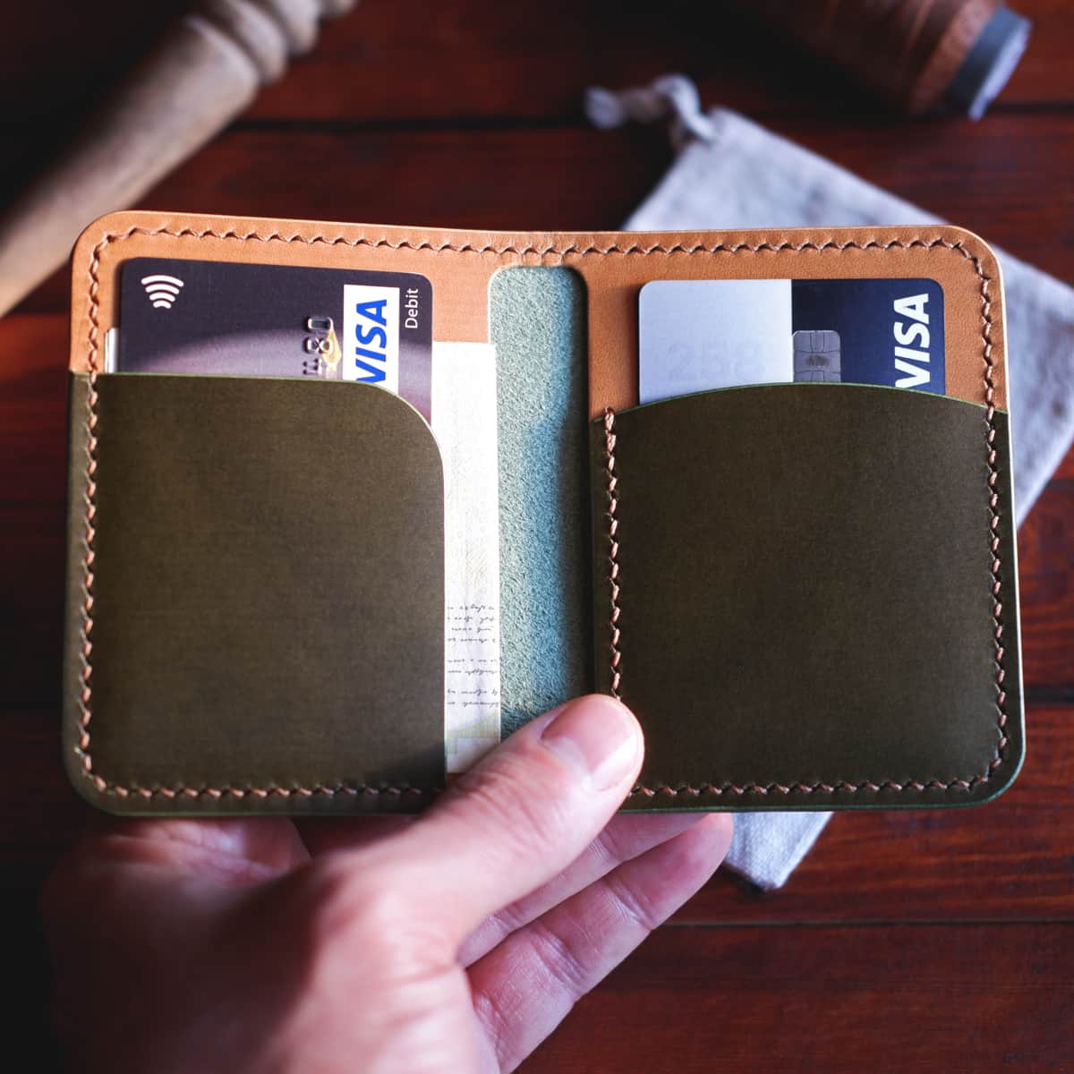 Interior closeup of The Mountain Bifold wallet with cards and cash inside 