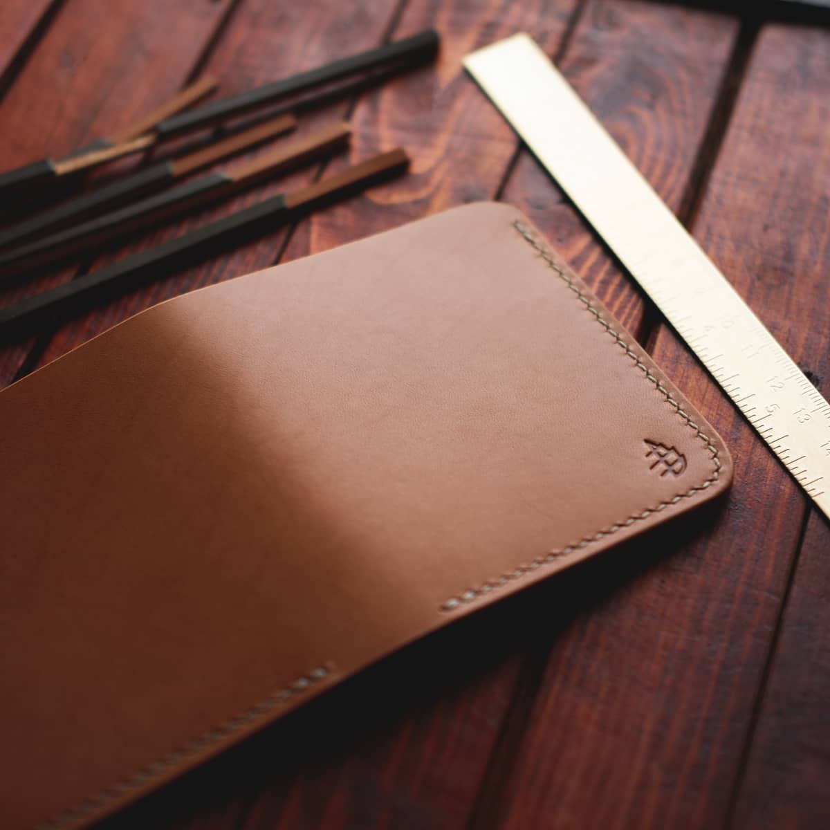 Tabletop view of The Mountain Open Top Bifold wallet in Buttero full grain vegetable tanned leather