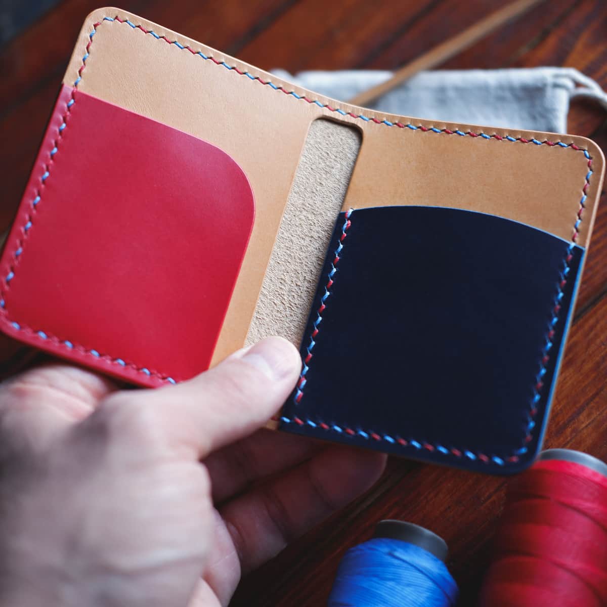 Interior closeup of The Mountain Bifold wallet with in Natural/Red/Blue Buttero