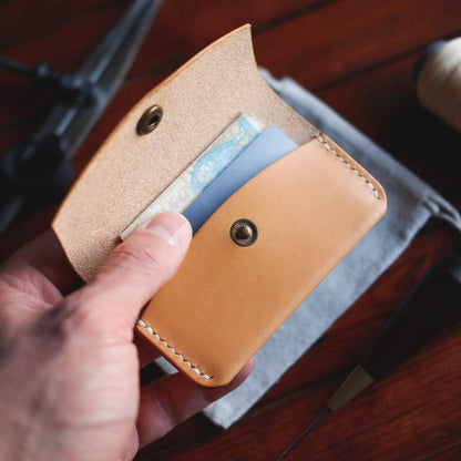 The Mountain Snap Wallet in Natural/Biscuit Buttero leather interior pictured with cards and cash
