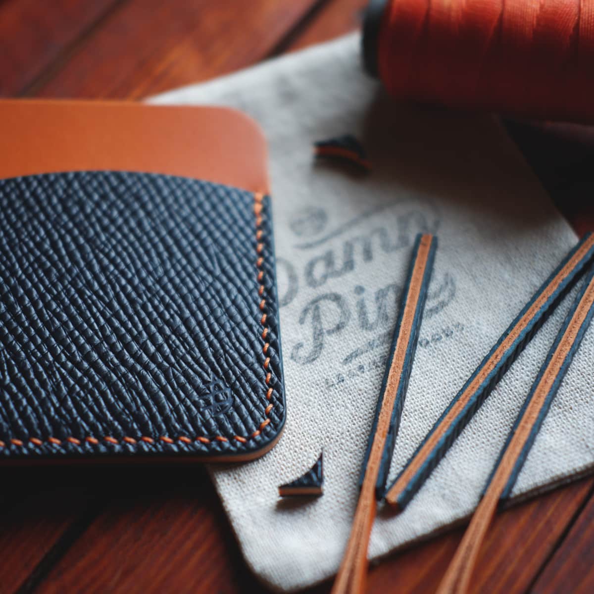 Closeup of The Palm Card Holder in Blue Buttero Hatch and Orange Koala vegetable tanned leathers