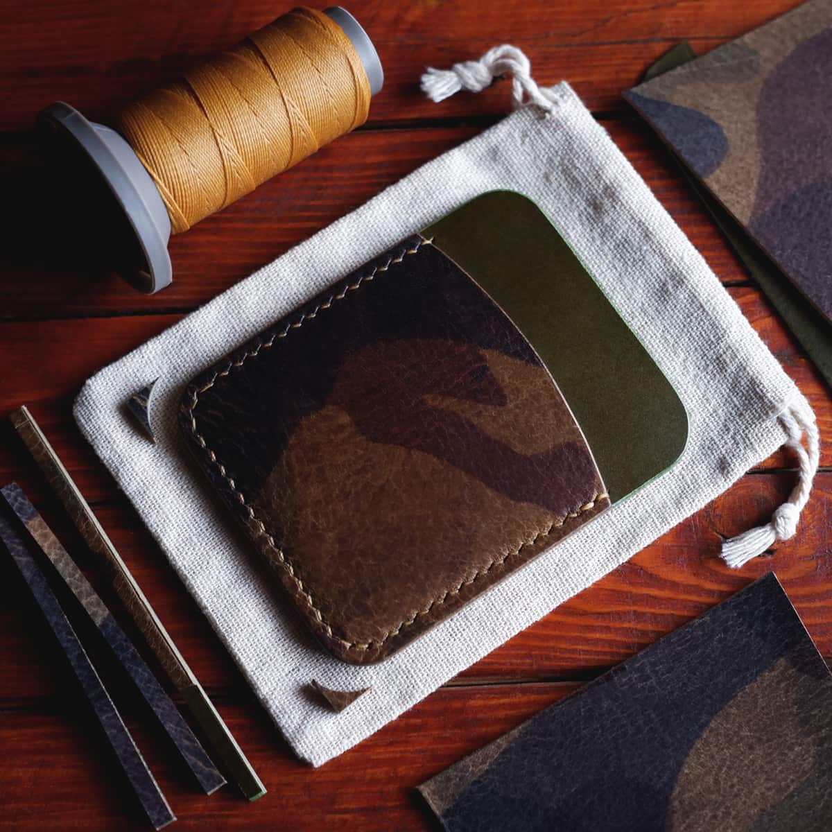 Tabletop view of The Palm Card Holder in El Vaquero and Olive Buttero vegetable tanned leathers