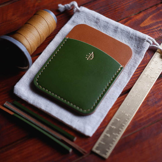 Tabletop view of The Palm Card Holder in Pistachio/Gold Koala vegetable tanned leather