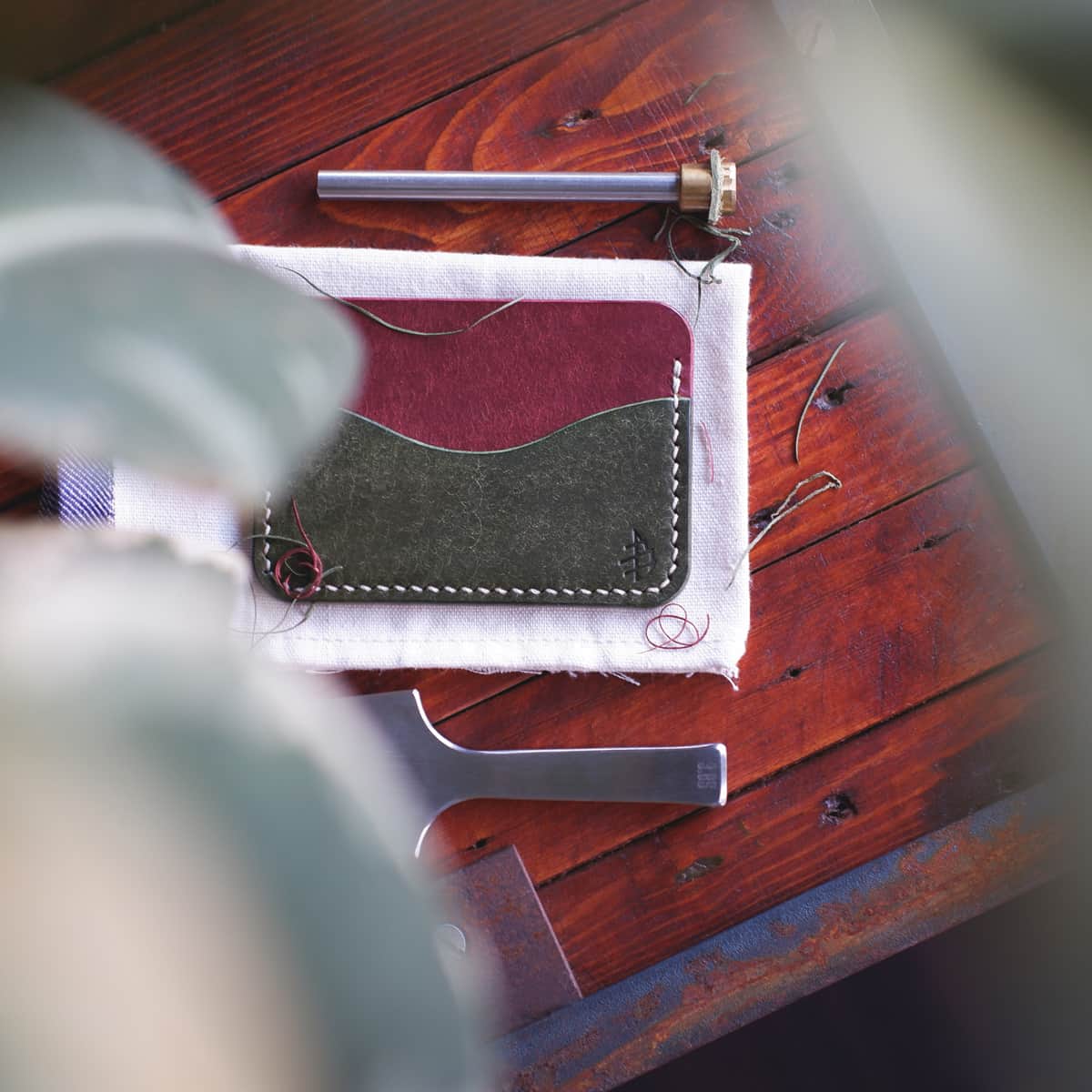 Tabletop view of The Pinyon Card Holder in Coccinella and Olive Pueblo vegetable tanned leather