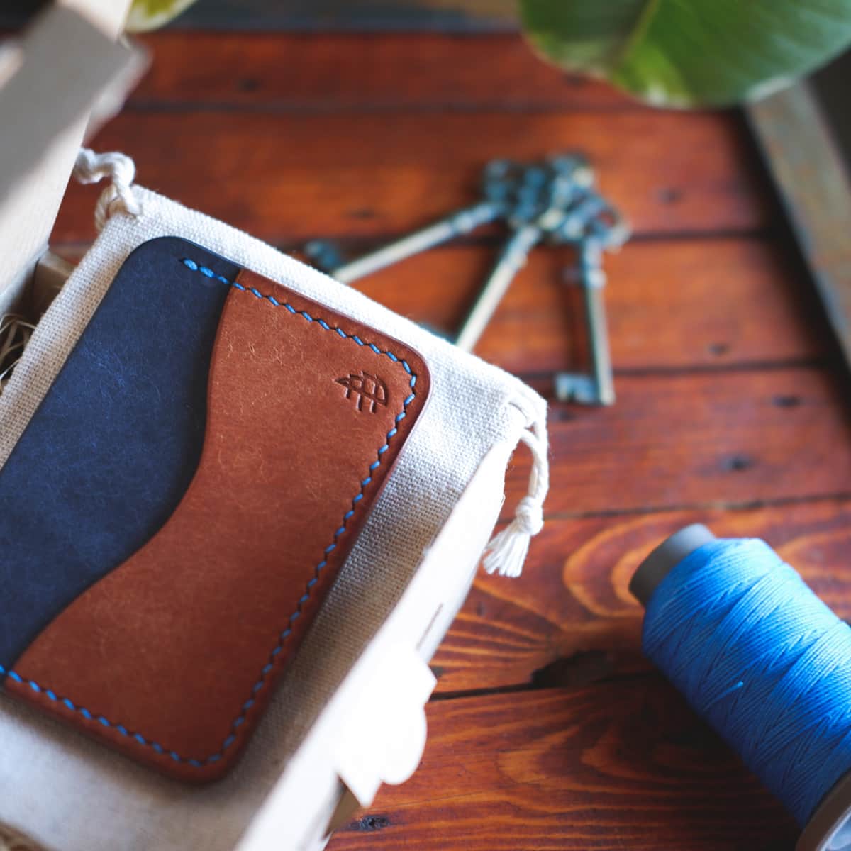 Tabletop view of The Pinyon Card Holder in Navy and Brown Margotta leather
