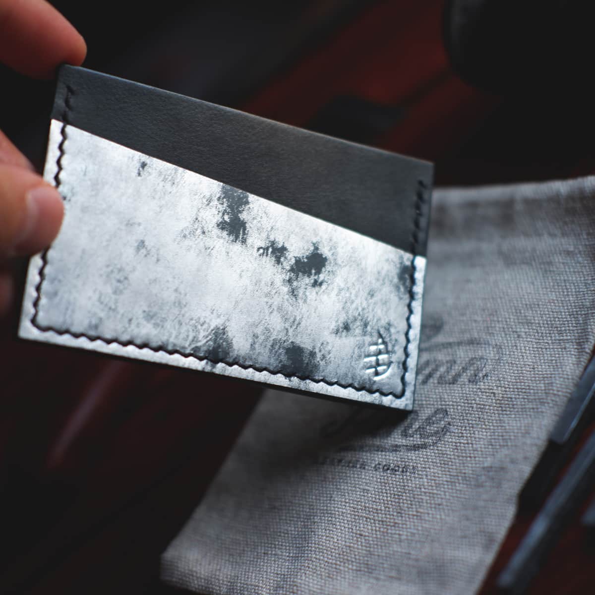 Closeup of The Scots Card Holder in Carbone Bisanzio and Black Graffiti vegetable tanned leather