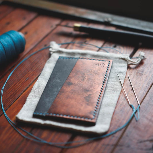 Tabletop view of The Scots Card Holder in Rame Bisanzio and Charcoal Maya vegetable tanned leather