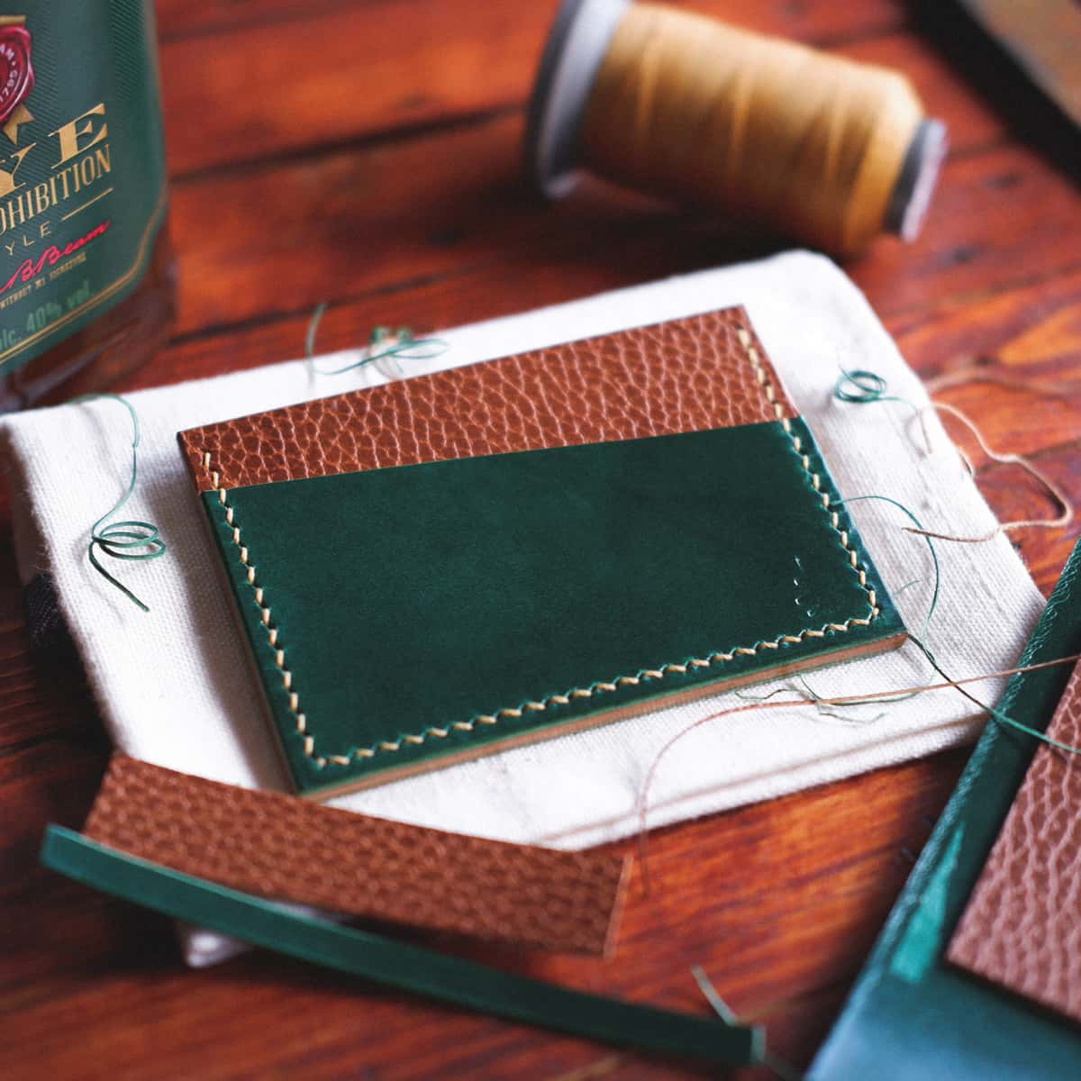 Tabletop view of The Scots Card Holder in Emerald Green Gaucho Oil and Brown Dollaro vegetable tanned leather