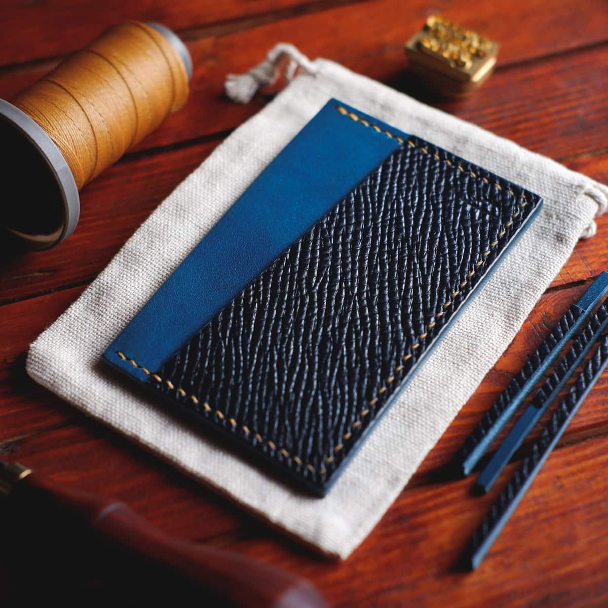 Tabletop view of The Scots Card Holder in Blue Buttero Hatch and Italico Tirreno vegetable tanned leathers