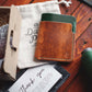 Tabletop view of The Vertical Card Holder in Brown Appaloosa and Emerald Green Gaucho Oil vegetable tanned leather
