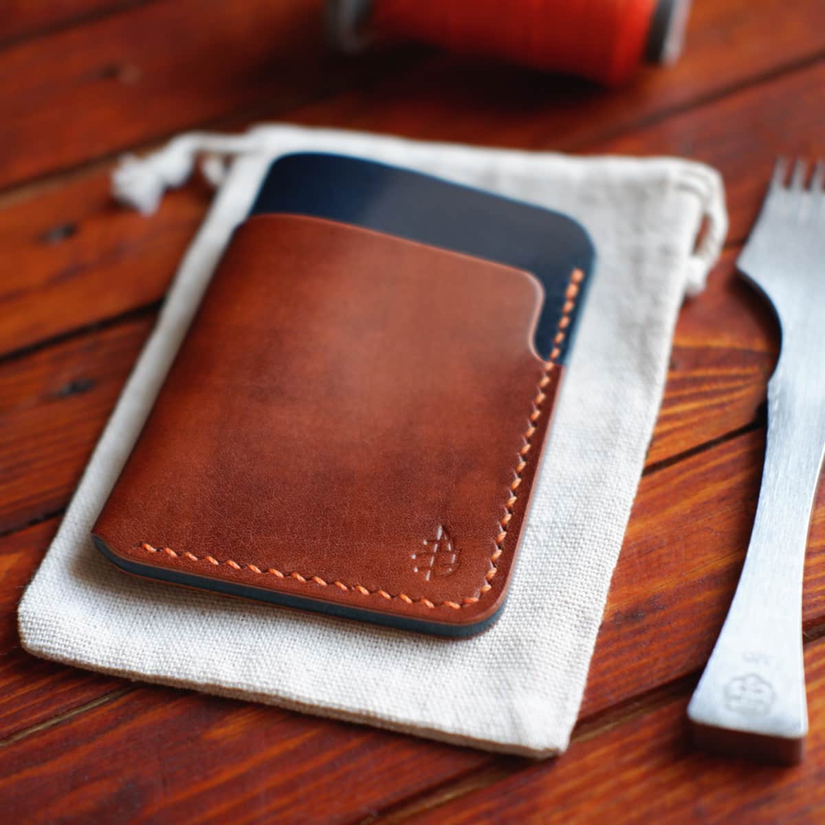 Closeup of The Vertical Card Holder in Italico Radica and Blue Gaucho Oil full grain vegetable tanned leather