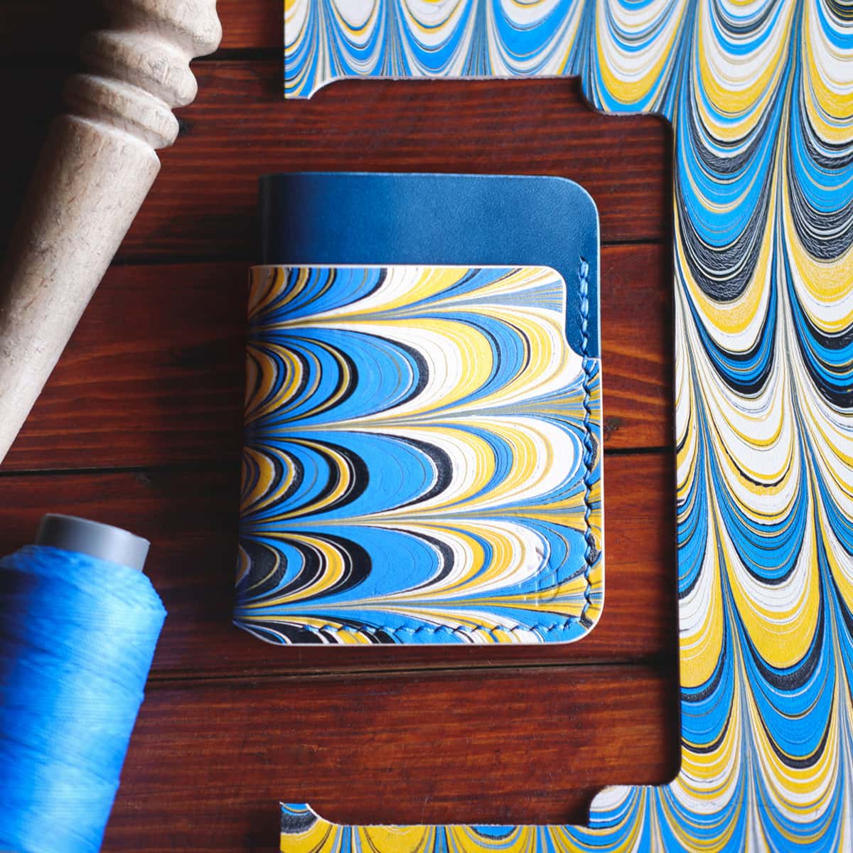 Tabletop view of The Vertical Card Holder in Italico Tirreno and hand dyed marbled vegetable tanned leather